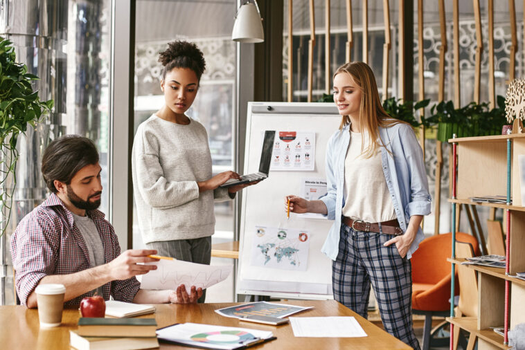 Marketing Agency ad. Three coworkers conversing