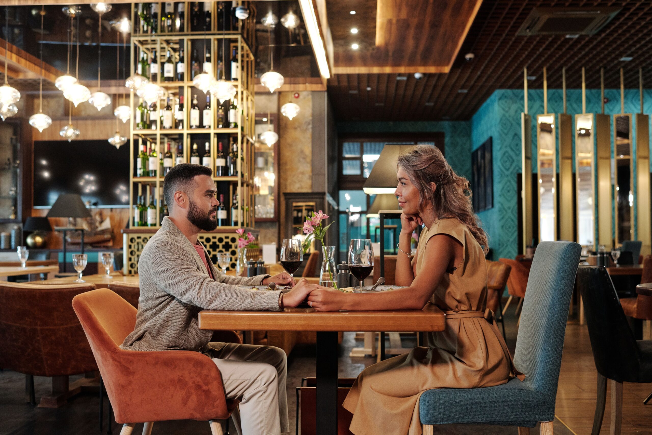 Couple enjoying a romantic dinner with wine in an elegant restaurant setting