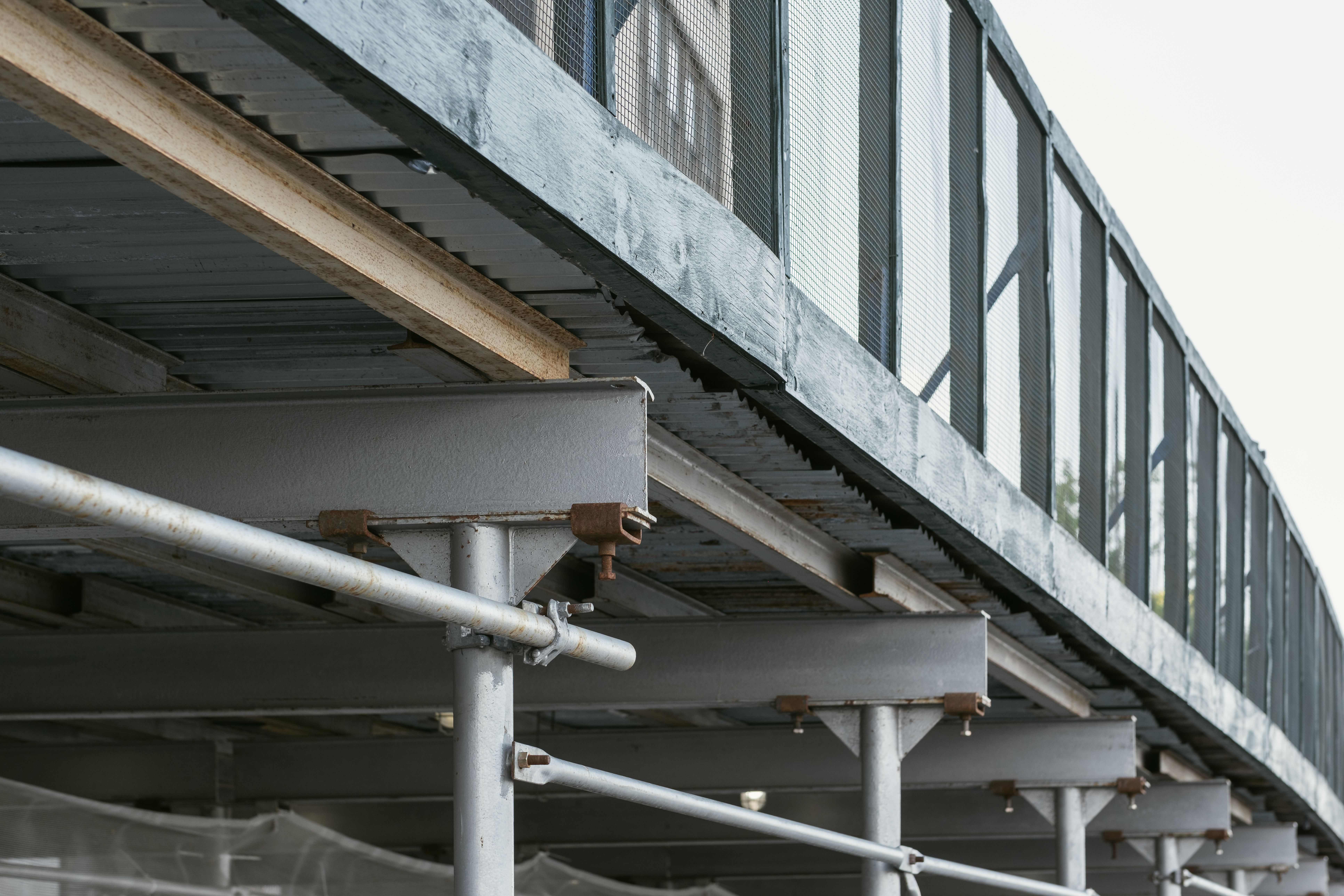 Close-up of an urban steel walkway structure showing the clean lines and industrial detailing associated with metal decking systems.