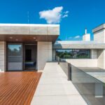 Sleek modern terrace with linear decking and open blue-sky views, illustrating contemporary outdoor deck design.